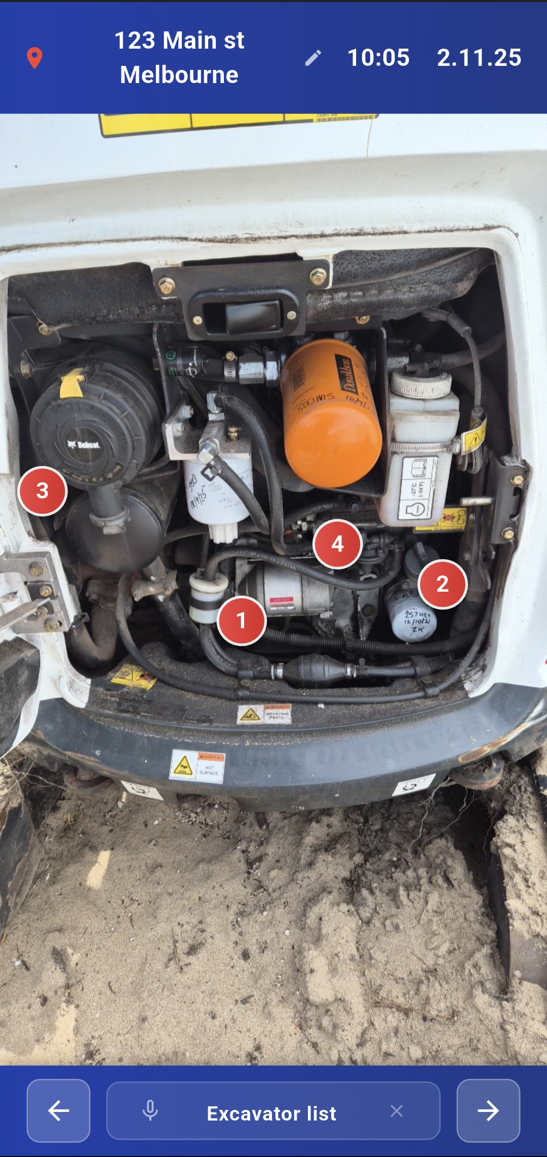 Excavator engine bay with red markers